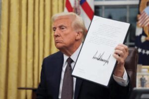 A photo of President Donald Trump holding up a document with his signature.
