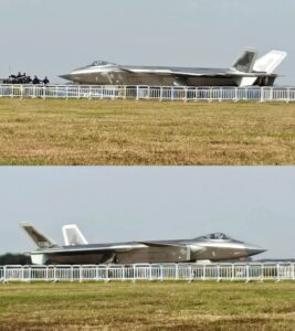 Alternative Text and a Caption for the J-20 image you provided are as follows:Alternative Text A high-angle close-up of a Chinese J-20 stealth fighter jet flying against a blue sky, showcasing its unique canard-delta wing design.