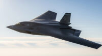 The U.S. Air Force's B-21 Raider stealth bomber, a sleek and futuristic aircraft, shown in mid-flight against a clear sky, highlighting its advanced design and stealth capabilities.